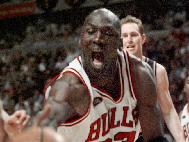 Chicago Bulls' Michael Jordan reaches for  ball as Utah Jazz forward Adam Keefe comes from behind during Game 4 of NBA Finals in Chicago, 10/06/98.Basketball A/CT