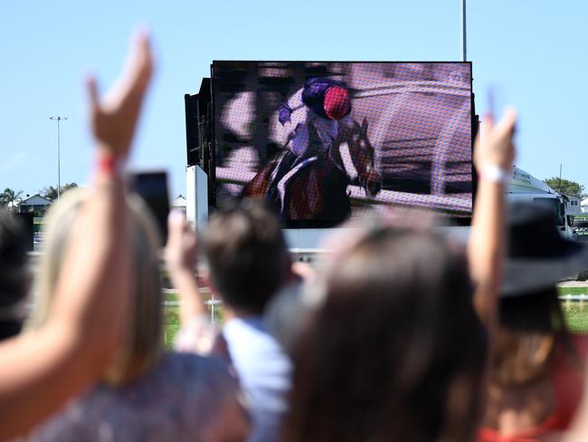 BRISBANE, AUSTRALIA - NewsWire Photos - NOVEMBER 3, 2020.A crowd watch Twilight Payment winning the Melbourne Cup on a big screen at Doomben Racecourse in Brisbane.Picture: NCA NewsWire / Dan Peled