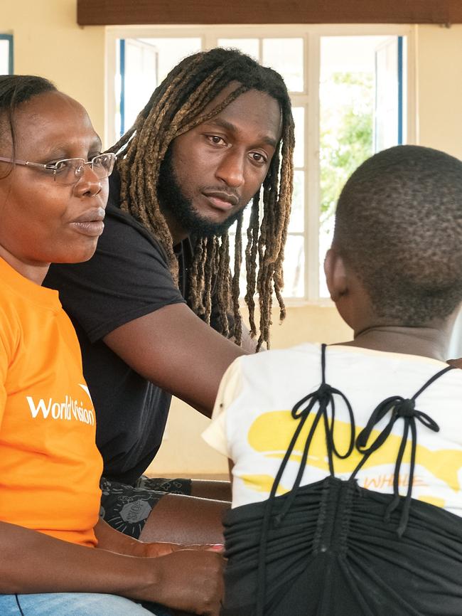 Listening to a child’s story in a rescue centre with a worker from World Vision. (Picture: Nick Ralph)