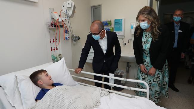 Liam gets a visit in the Platypus Ward from Acting Premier James Merlino and chairman of the Herald & Weekly Times Penny Fowler. Picture: Alex Coppel