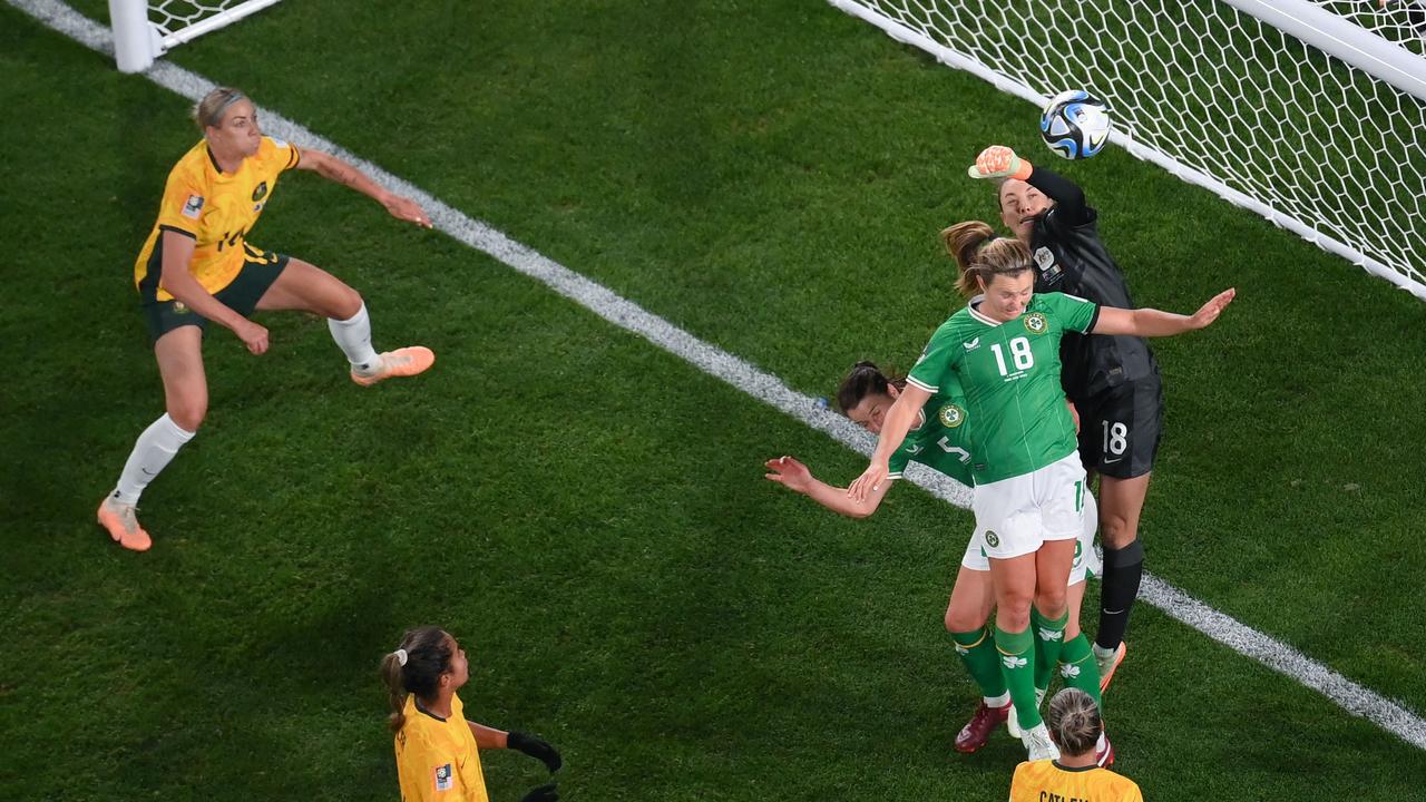 Mackenzie Arnold (R) punches the ball clear under pressure. Picture: AFP