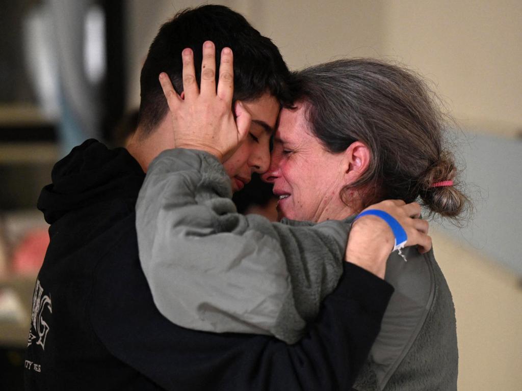 Sharon Hertzman Avigdori embracing her son after she was released along with her daughter from Hamas captivity. Picture: Haim ZACH / Israeli Government Press Office / AFP