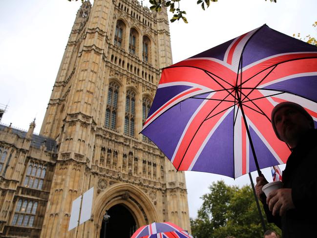 A Brexit activist holds a Union Flag-themed umbrella as he demonstrates outside of the Houses of Parliament in central London on October 21, 2019. Picture: AFP