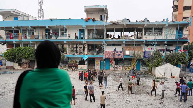 Palestinians check a UN-school that was hit during Israeli bombardment in Nuseirat, in central Gaza.