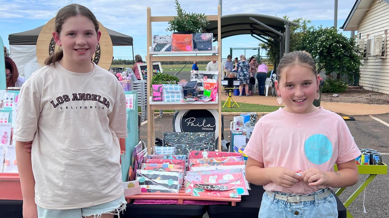 Paila Designs business owners Paisley (left) and Layla (right) selling their handmade clutches.