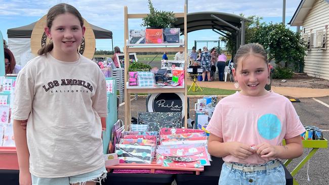 Paila Designs business owners Paisley (left) and Layla (right) selling their handmade clutches.