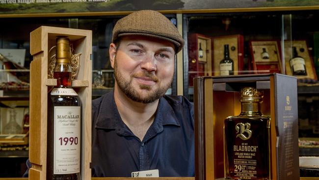 Dan Murphy’s Mermaid Waters Whisky Expert Matt Loth with the most expensive bottle they have in store - a Macallan Fine &amp; Rare Single Malt Scotch 1990 Scotch Whisky which retails for $17,000 and a bottle - and a Bladnoch Bicentennial 2970, which costs a mere $8,800. Picture: Jerad Williams.