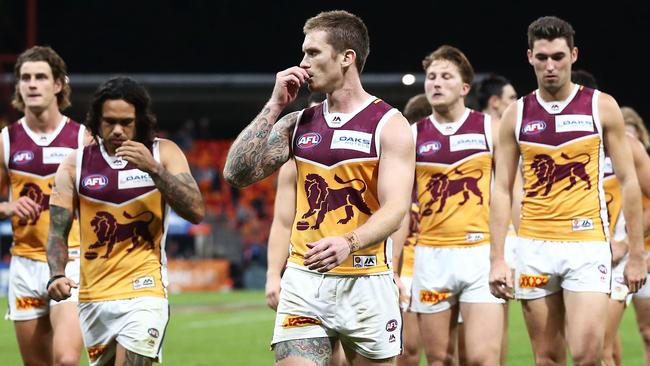 Dayne Beams leads Brisbane off after a loss.