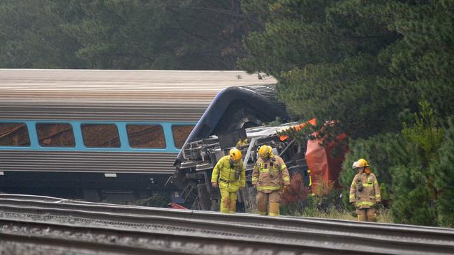 Firefighters at the scene of the train derailment on Friday morning. Picture: Andrew Henshaw