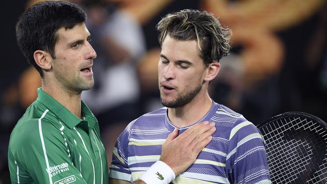 Serbia's Novak Djokovic, left, is congratulated by Austria's Dominic Thiem after winning the men's singles final at the Australian Open tennis championship in Melbourne.