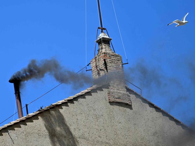 This photograph shows black smoke rising from the chimney of the Sistine Chapel signalling that cardinals failed to elect a new pope during their conclave in the Vatican. Picture: Getty