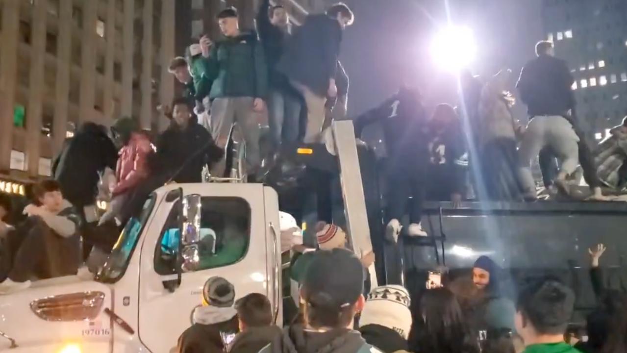 Fans celebrate on top of a garbage truck. Photo/X