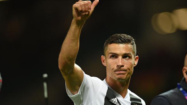 Cristiano Ronaldo gestures to supporters after the Champions League between Manchester United and Juventus