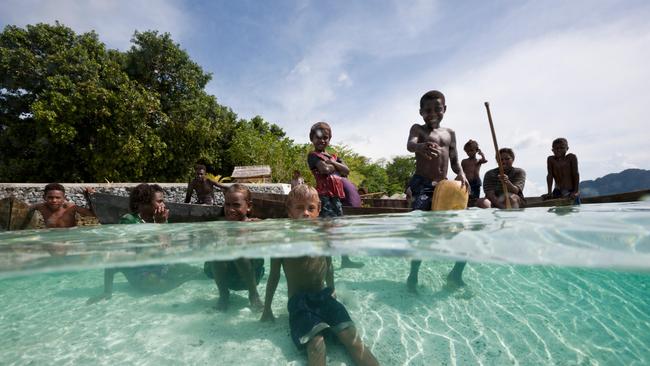 Children play in a lagoon at Florida Islands, on Solomon Islands.