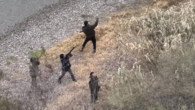 A man holds a gun up at apparently a drone. Picture: Texas Department of Public Safety.