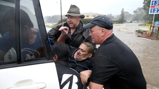 A man was rescued by local residents after they found him clinging to a tree in raging floodwaters at Telegraph Point on the state’s north. Picture: Nathan Edwards