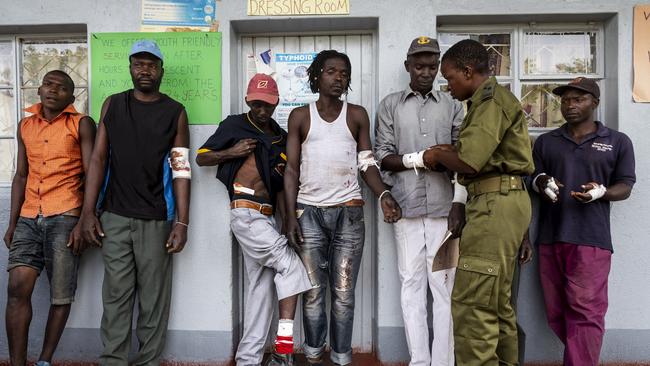 Seven village men injured by a leopard receive treatment from Akashinga Sergeant Vimbai Kumire. The men were injured when they pursued and killed a leopard that had strayed into their fields. Picture Brent Stirton