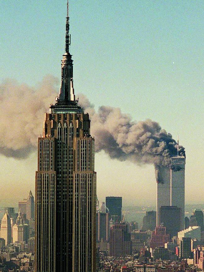 The twin towers of the Twin Towers burn behind the Empire State Building. Picture: AP