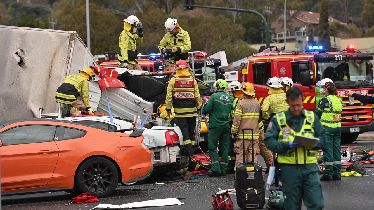 Emergency services work to release people trapped in wreckage after the July 2022 smash at the bottom of the freeway. Picture: Keryn Stevens