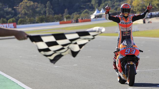 Moto GP World Champion winner Marc Marquez of Spain crosses the finish line after finishing third at the Valencia Motorcycle Grand Prix, the last race of the season, at the Ricardo Tormo circuit in Cheste near Valencia, Spain, Sunday Nov. 12, 2017. Marquez won his fourth MotoGP world title on Sunday after challenger Andrea Dovizioso crashed during the season-concluding Valencia Grand Prix. (AP Photo/Alberto Saiz)