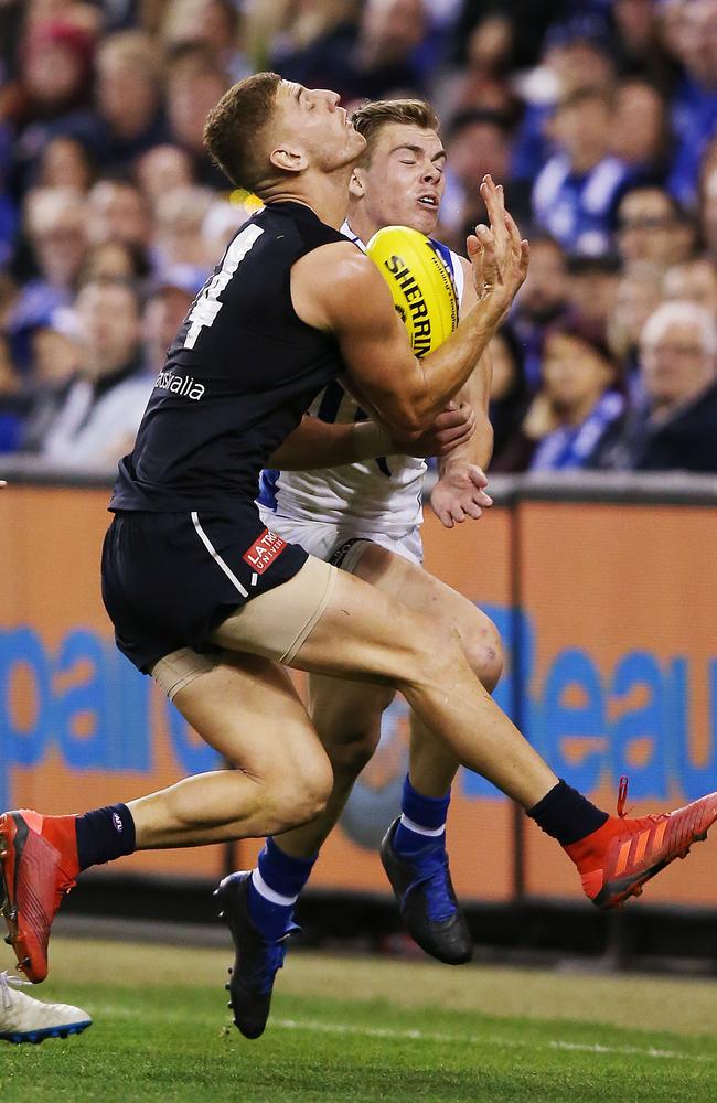 Liam Jones collides with North Melbourne’s Cam Zurhaar.