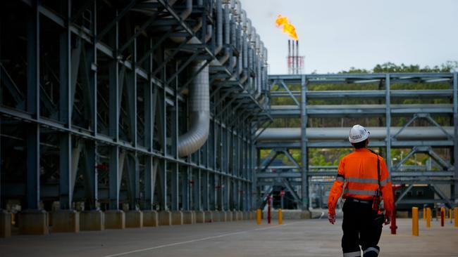 A worker walks through the Queensland Curtis Liquefied Natural Gas (QCLNG) project site. Picture: Patrick Hamilton/Bloomberg via Getty Images