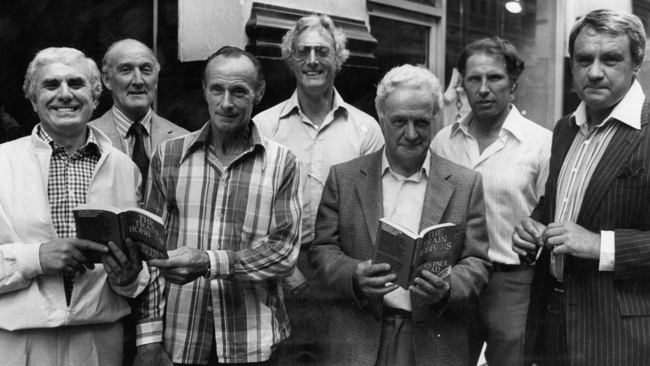 The Great Train Robbers, reunion in 2013 left to right: Buster Edwards, Tom Wisbey, Jim White, Bruce Reynolds, Roger Cordrey, Charlie Wilson and Jim Hussey, with copies of their book 'The Train Robbers'. Picture: Images Getty