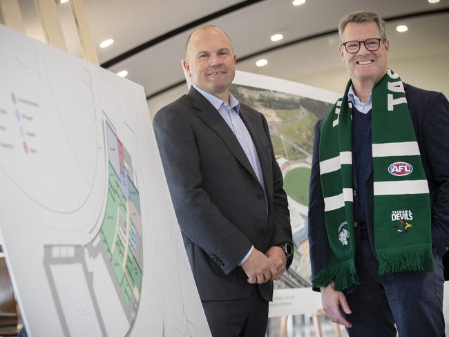 Waypoint Managing Director Chris Dare and Tasmania Football Club Chair Grant O'Brien with photos of Brisbane Lions and Sydney Swans High Performance Centre's which will be used in the Tasmania design.  Picture: Chris Kidd