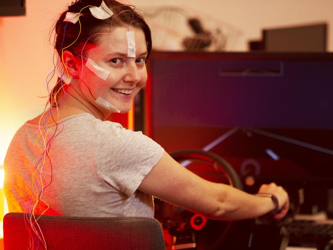 ADELAIDE, AUSTRALIA - Advertiser Photos FEBRUARY 26, 2021: Dr Steph Chappel, researcher at the Appleton Institute in Adelaide, "driving" the car simulator with electrodes attached to her head. Research to find out what level of fatigue or sleep loss is unsafe on the road conducted at CQUniversity Adelaide - The Appleton Institute is at 44 Greenhill Road, Wayville. Picture: Emma Brasier