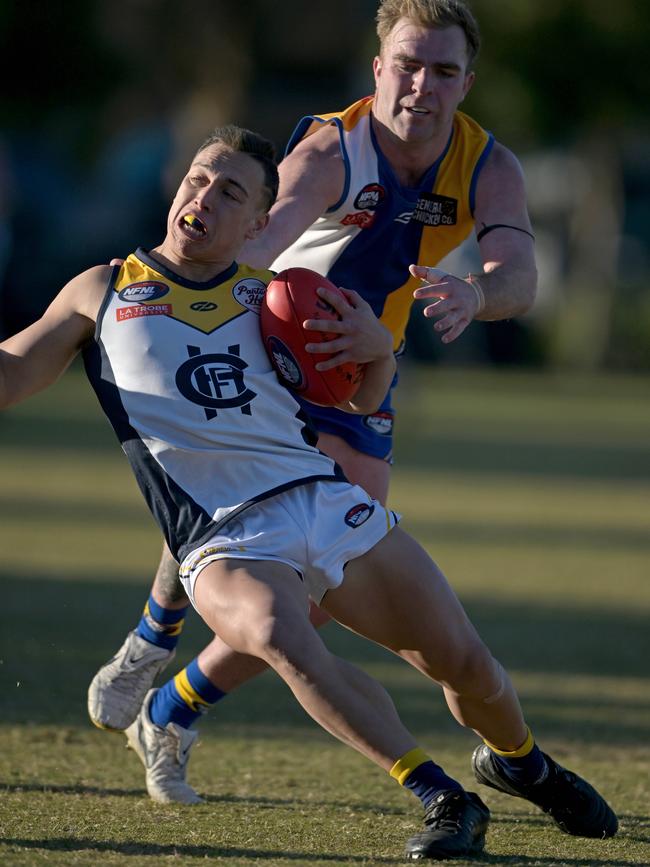 NFNL: Hurstbridge’s William Cookson is collared by Reid Brandt of Macleod. Picture: Andy Brownbill