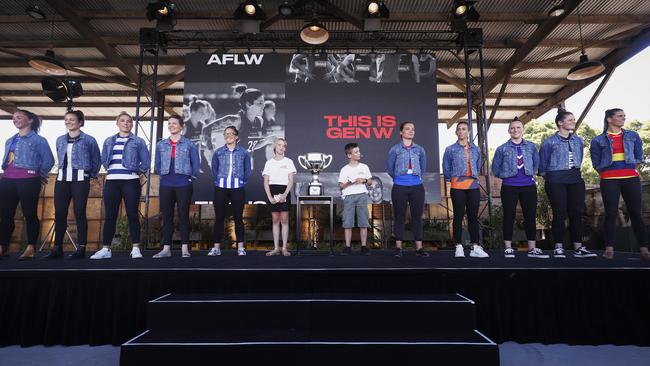 What’s going on here? AFLW captains were made to wear denim jackets in searing heat at the AFLW season launch.