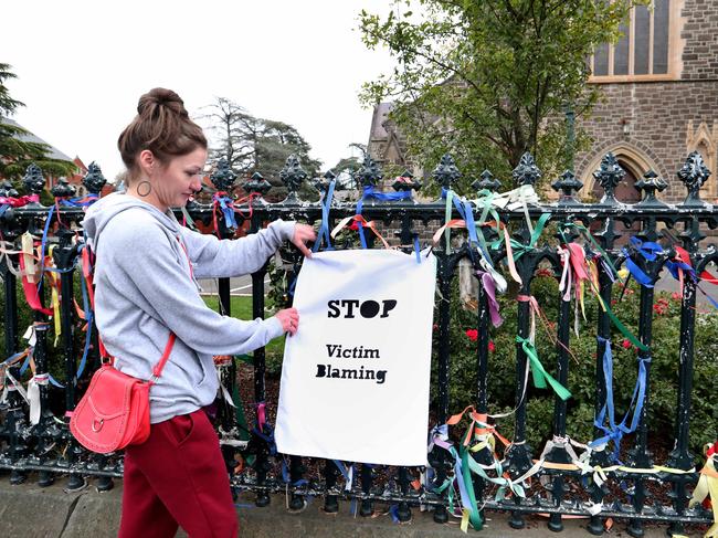 07/04/2020 Holly Baker from Ballarat places a sign outside St Patricks Cathedral in Ballarat after Cardinal George has been acquitted of child sex offences.Picture: David Geraghty / The Australian.