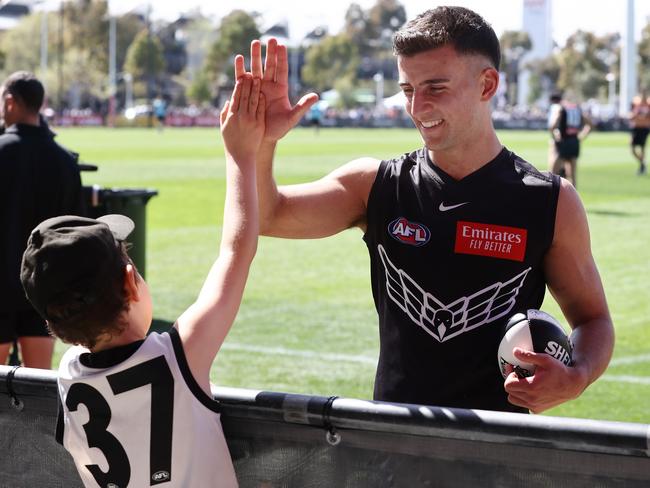 Nick Daicos of the Magpies high-five a fan after a training session at Olympic Park, Melbourne. Picture: Michael Klein