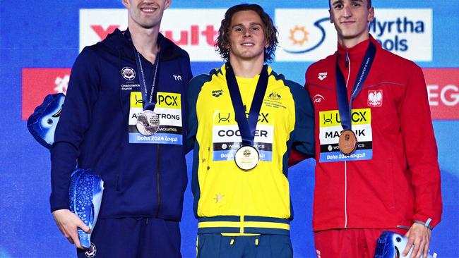 DOHA, QATAR - FEBRUARY 18: (L-R) Silver Medalist, Hunter Armstrong of Team United States, Gold Medalist, Isaac Cooper of Team Australia and Bronze Medalist, Ksawery Masiuk of Team Poland pose with their medals during the Medal Ceremony after the Men's 50m Backstroke Final on day seventeen of the Doha 2024 World Aquatics Championships at Aspire Dome on February 18, 2024 in Doha, Qatar. (Photo by Quinn Rooney/Getty Images)