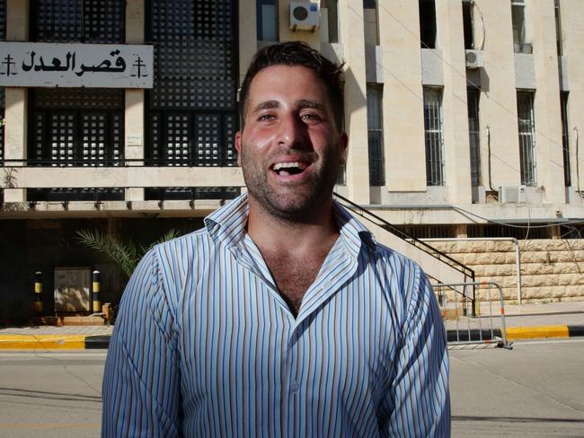 Ali Elamine laughs outside the courthouse where a deal has been reached by all parties. Picture: Liam Kidston