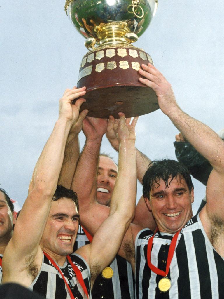 Port Adelaide vice-captain Tim Ginever (l), Roger Delaney (at the rear) and captain Greg Phillips hoist aloft the Thomas Seymour Hill premiership cup. in 1992, Picture: Martin Jacka