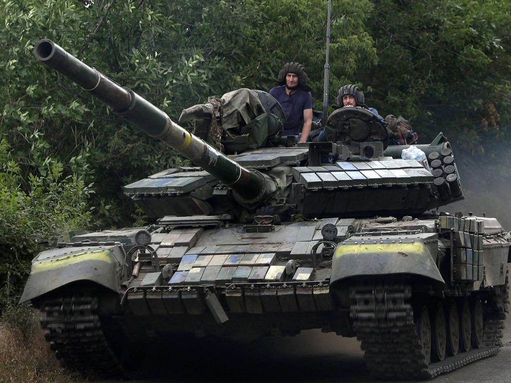 Ukrainian soldiers ride a tank on a road of the eastern Luhansk region. Picture: Anatolii Stepanov / AFP