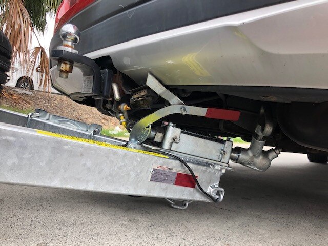 The trailer wedged under Trish Harris's car at Bunnings Oxenford.