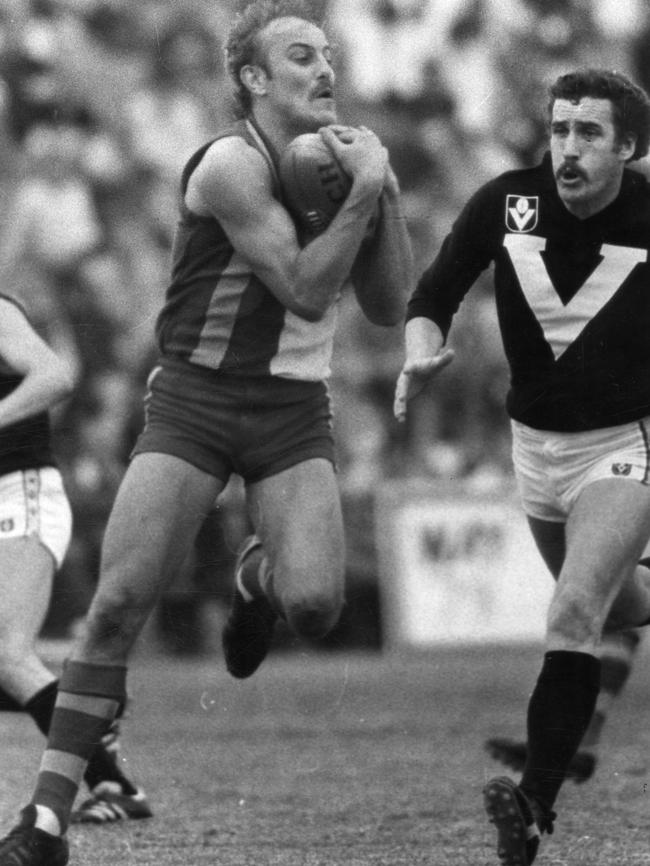 Malcolm Blight takes a chest mark in front of Kelvin Moore during the 1980 State of Origin game.