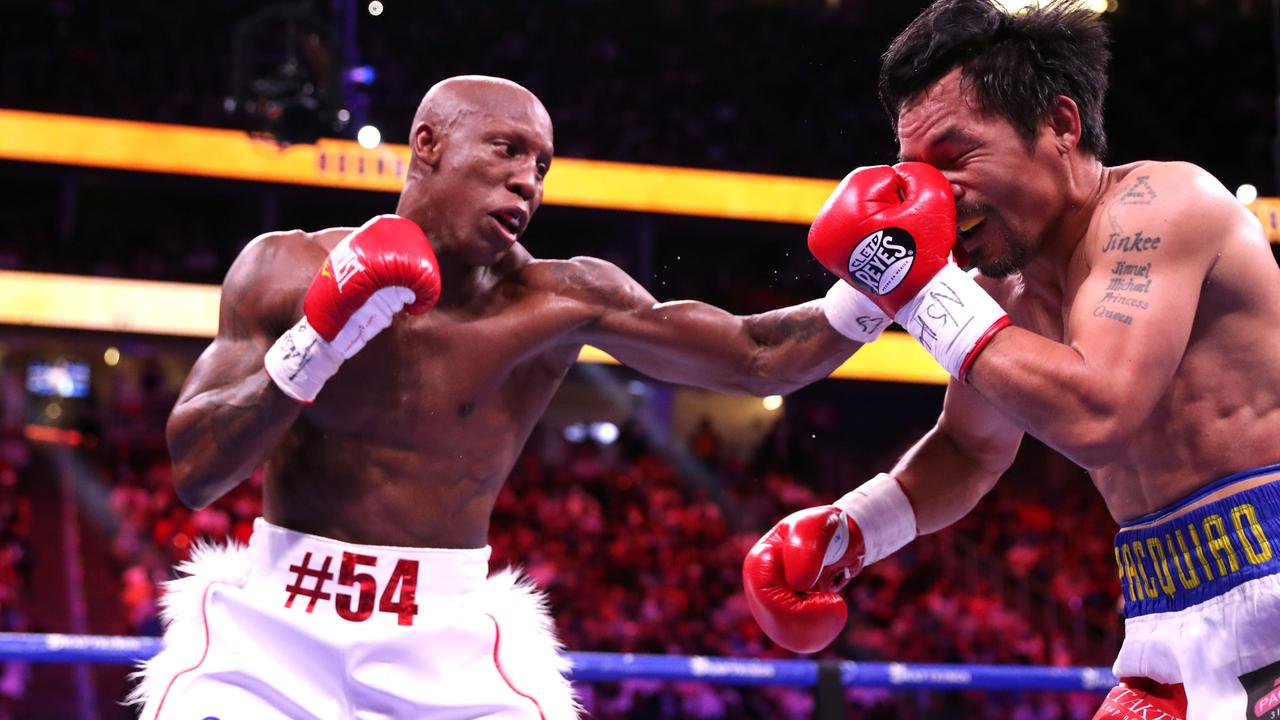 Yordenis Ugas (L) punches Manny Pacquiao during their WBA welterweight title fight.