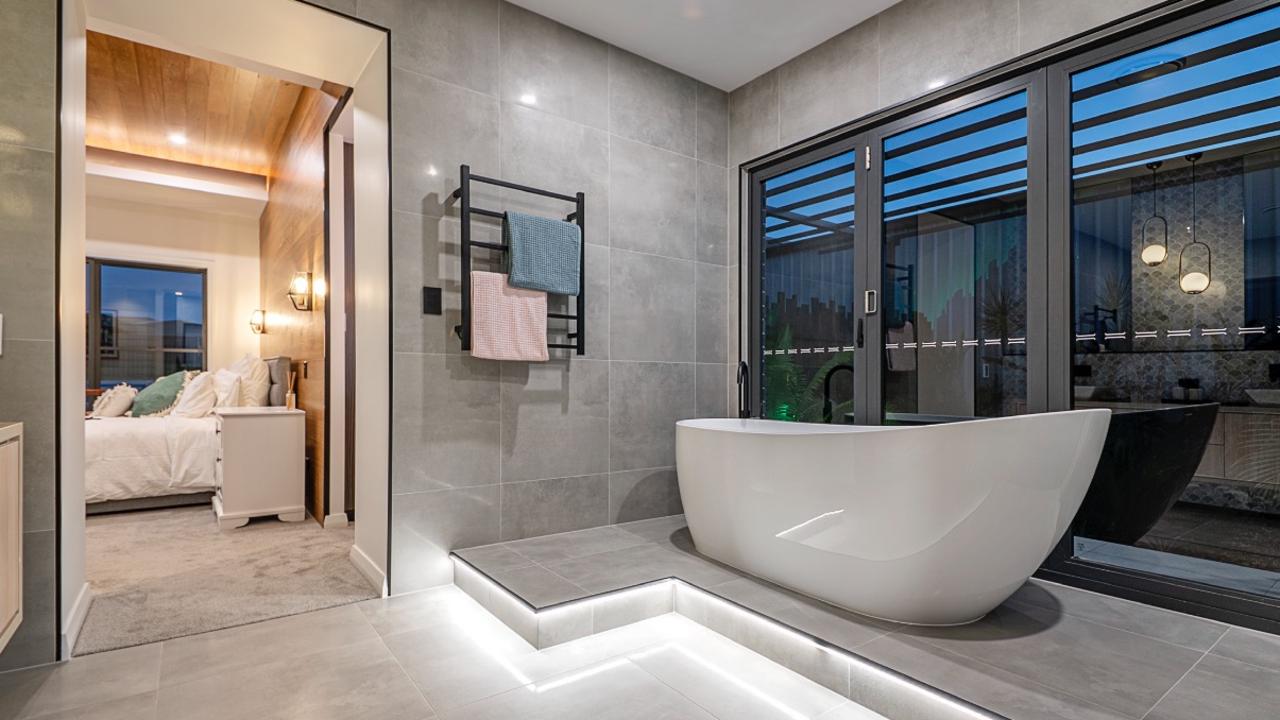 Hughes Elite Builders award-winning resort-style bathroom, featuring bi-fold doors. Photo: Hughes Elite Builders