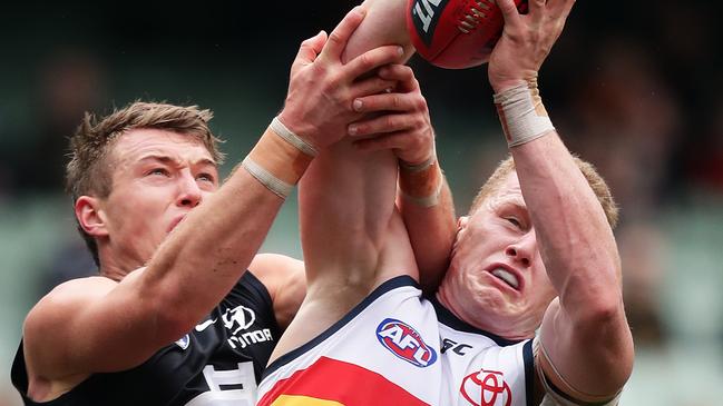 Reilly O'Brien of the Crows takes a mark under pressure from Patrick Cripps of the Blues. Picture: Matt King/Getty Images