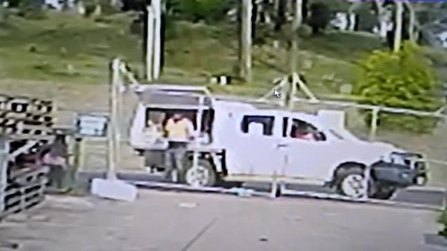 An Australia Post delivery driver is seen throwing a package over a fence at a Highfields business. Video- Supplied