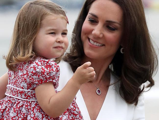 WARSAW, POLAND - JULY 17:  Catherine, Duchess of Cambridge carries Princess Charlotte of Cambridge as they arrive with Prince William, Duke of Cambridge and Prince George of Cambridge on day 1 of their offical visit to Poland on July 17, 2017 in Warsaw, Poland.  (Photo by Chris Jackson/Getty Images)