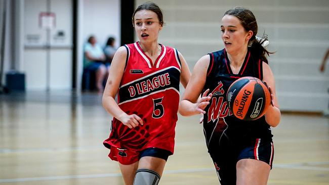 Norwood’s Polly Tuner dribbles the ball during the Flames’ under-14 girls grand final win over Sydney Diamonds at the Adelaide Easter Classic. Picture: Mike Burton