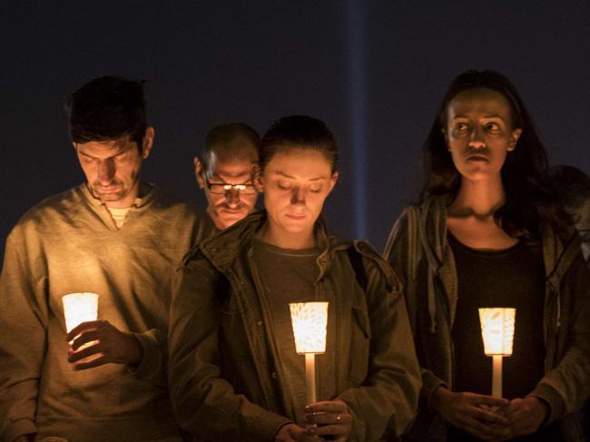 LAS VEGAS, NV - OCTOBER 3: At the corner of Sunset Road and Las Vegas Blvd., mourners attend a candlelight vigil for the victims of Sunday night's mass shooting, October 3, 2017 in Las Vegas, Nevada. Late Sunday night, a lone gunman killed over 50 people and injured over 500 people after he opened fire on a large crowd at the Route 91 Harvest country music festival. The massacre is one of the deadliest mass shooting events in U.S. history.   Drew Angerer/Getty Images/AFP == FOR NEWSPAPERS, INTERNET, TELCOS & TELEVISION USE ONLY ==