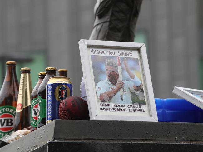 Tributes laid at the statue of Shane Warne at the Melbourne Cricket Ground. Picture: David Crosling