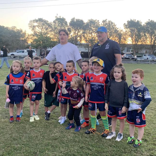 Reece Walsh helps out at junior footy.