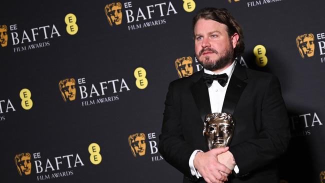 TOPSHOT - US director Brady Corbet poses with the award for Best director for "The Brutalist" during the BAFTA British Academy Film Awards ceremony at the Royal Festival Hall, Southbank Centre, in London, on February 16, 2025. (Photo by JUSTIN TALLIS / AFP)