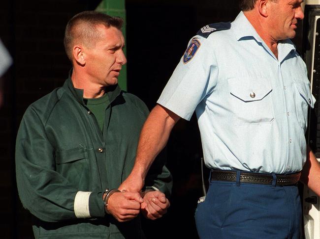 Anita Cobby murderer John Travers being led from Bowral Police Station in 1996 after an attempted escape.